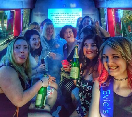 ladies enjoying the party inside the bus with alcohol.